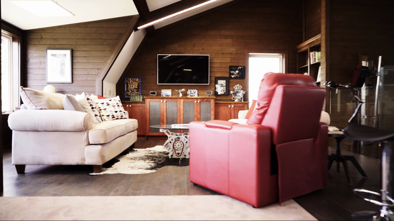 A cozy living space with wood panel walls.