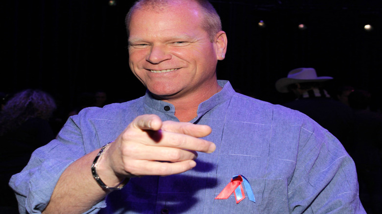 Mike Holmes smiling and pointing at the camera.