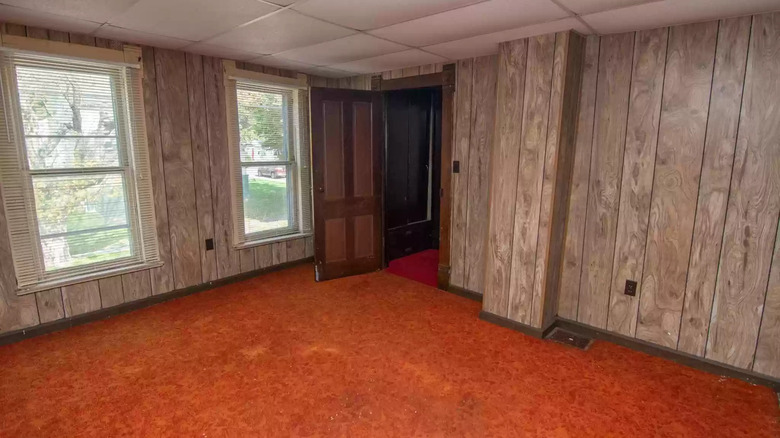 Wood paneled walls orange carpet
