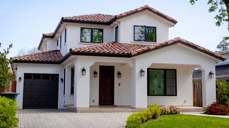 A two-story house with a white facade