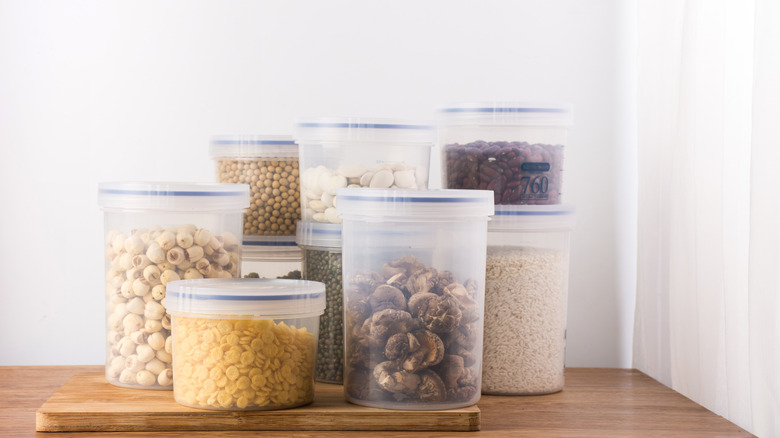 Clear deli containers sit on a shelf.