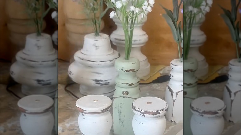 Spindle vases with floral stems