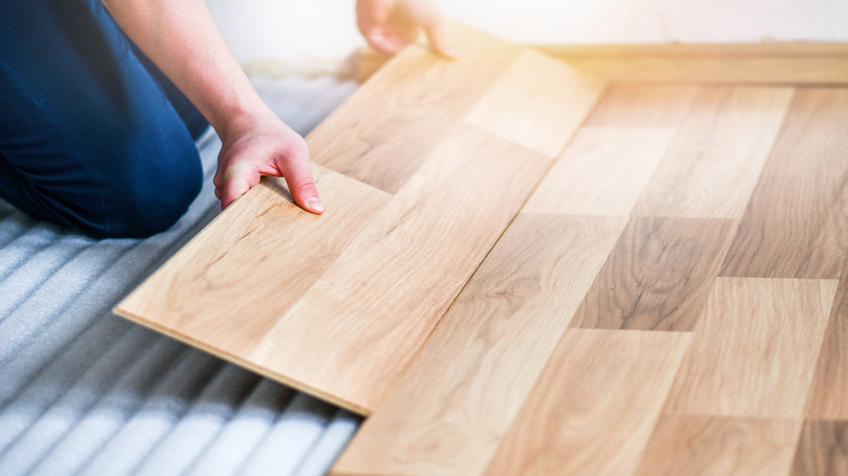 Person laying laminate flooring