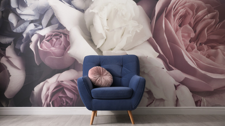 Blue chair with floral wallpaper
