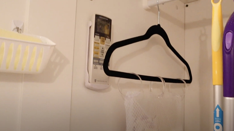 Hanging storage solution using a hanger, mesh bag, and shower curtain rings