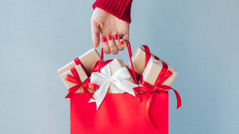 Hand holding red gift bag