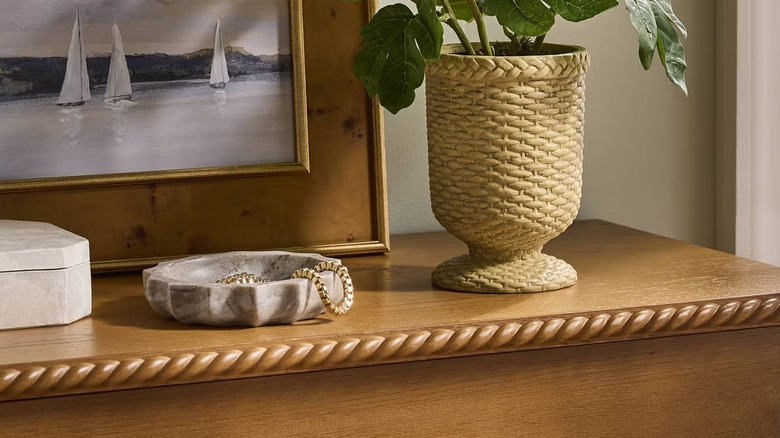 Threshold's Marble Catchall Tray displayed atop a dresser.