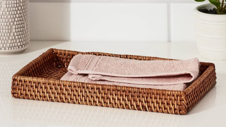 Threshold's Rattan Tray displayed artfully on a countertop.