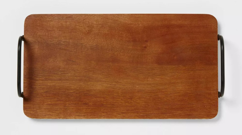 Cheese, crackers, and grapes displayed atop Threshold's Wood Serving Board.