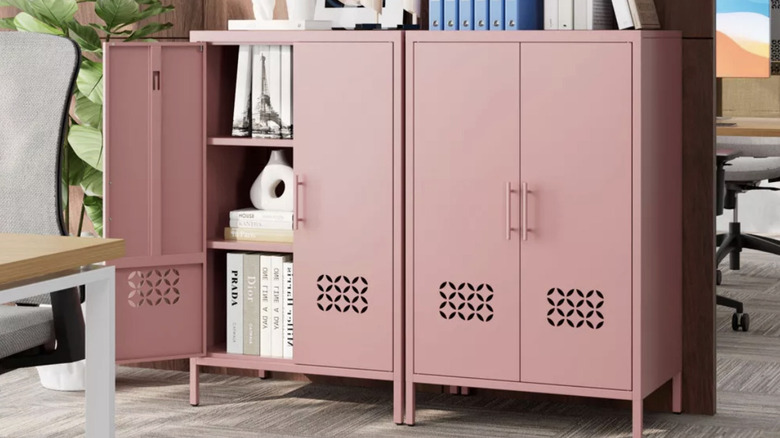 Two pink metal cabinets sitting side-by-side in an office