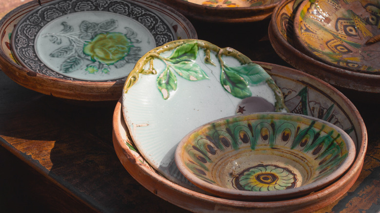 Several brightly colored antique dishes staked together