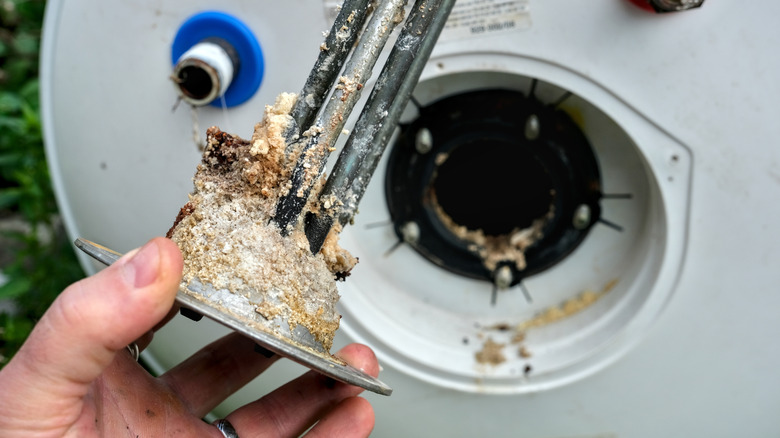 Water heater heating element covered in sediment