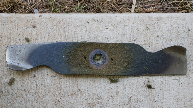 A worn down lawn mower blade
