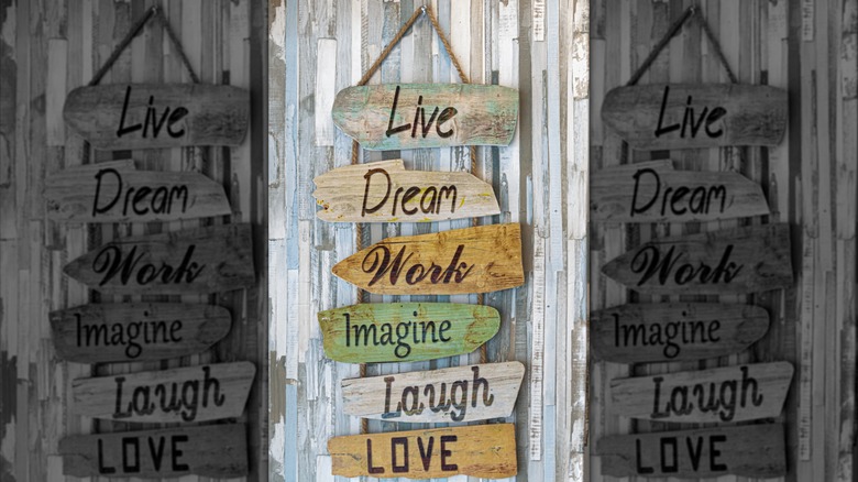 A hanging sign that says "live, dream, work, imagine, laugh, love."