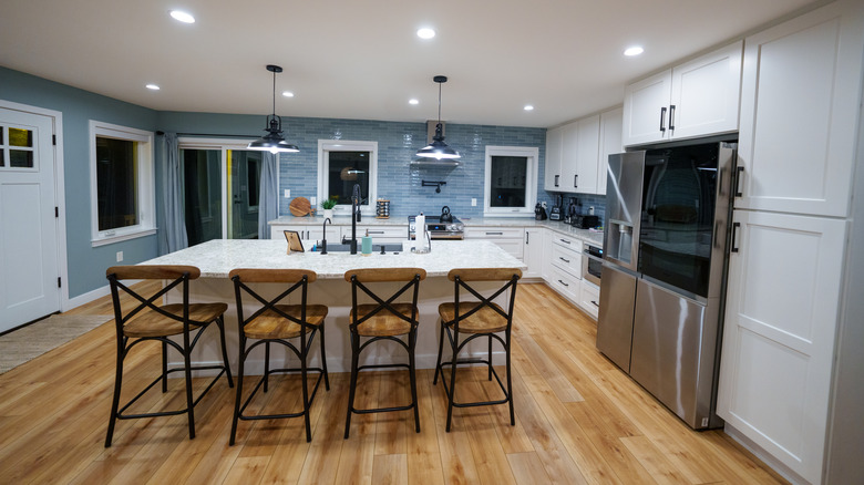 A 2010s kitchen in a modern farmhouse with blue subway tile backsplash..