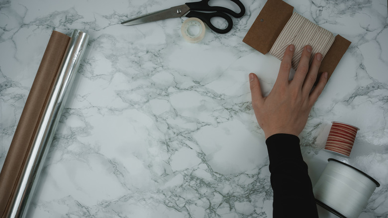 A marble contact paper surface with desk supplies on it.