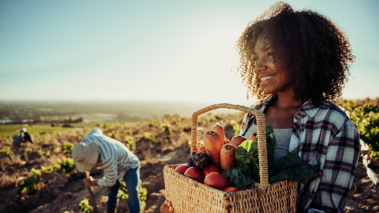 woman holding basket of produce