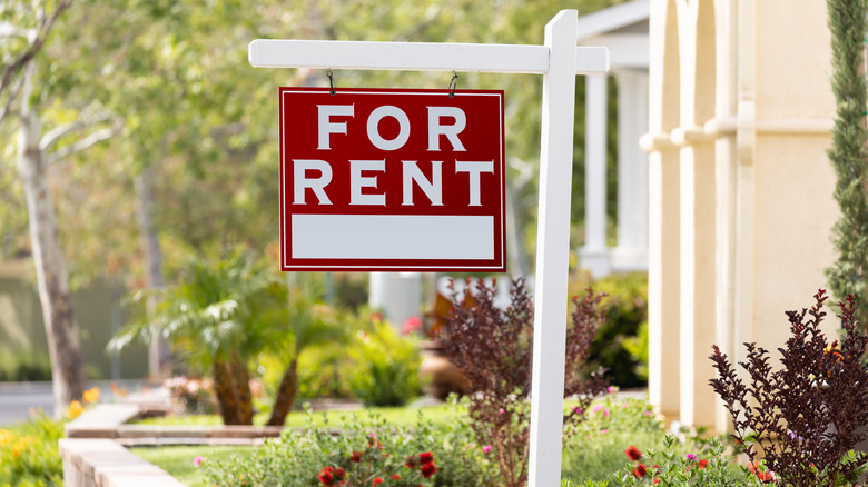 "For Rent" sign in yard