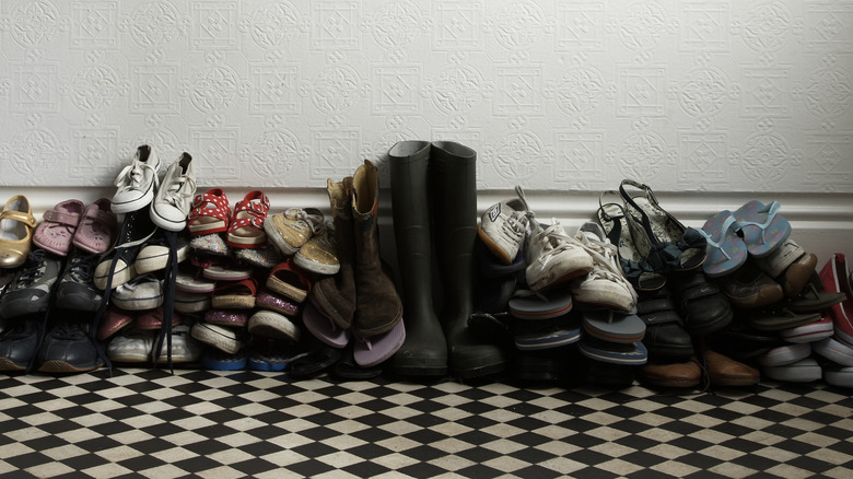 An untidy pile of shoes and boots