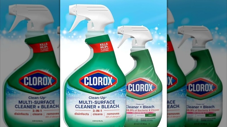 Spraying Clorox Clean-Up Multi-Surface Cleaner on white cabinet