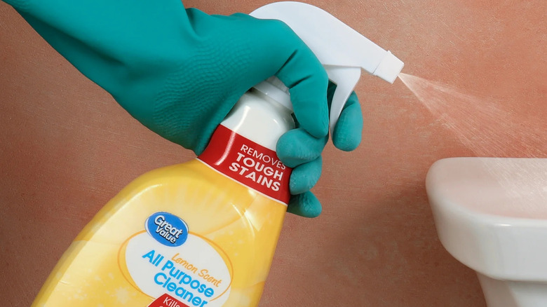 Spraying Great Value Bleach-free All Purpose Cleaner on a paper towel in kitchen