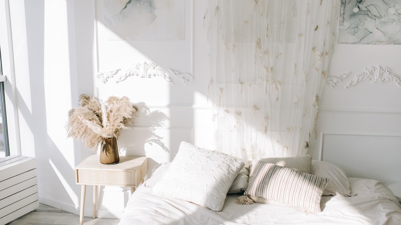 Bright white walls in a bedroom with an open window
