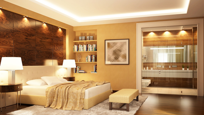 A pale gold room with white and brown notes in the furniture and bed