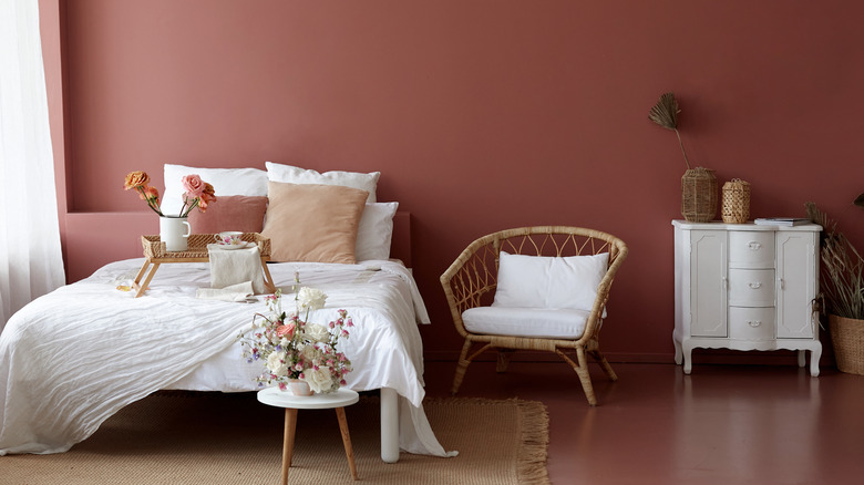 Terra cotta walls lend a warm, neutral feel to the bedroom.