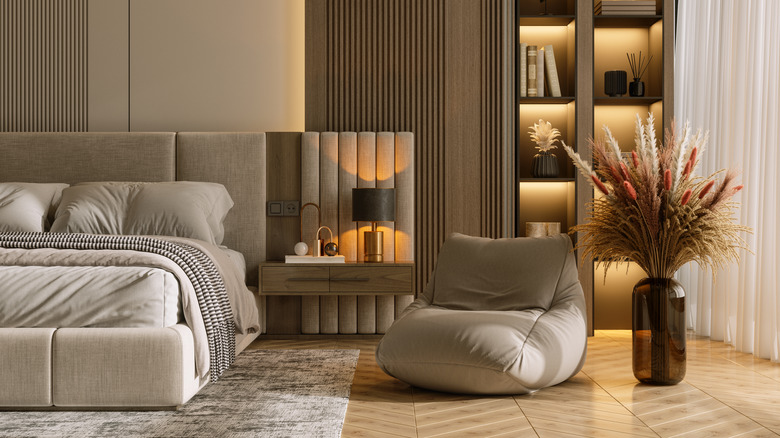 A cozy bedroom is seen in which the bed is a good distance from the window.