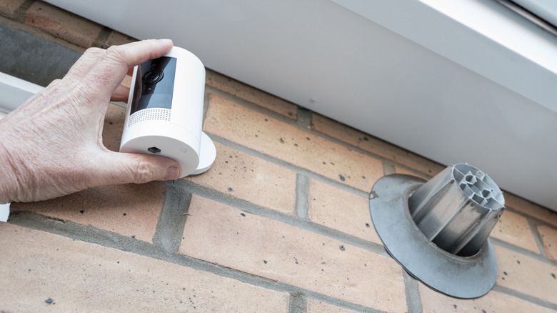 Security camera being installed near a central air vent