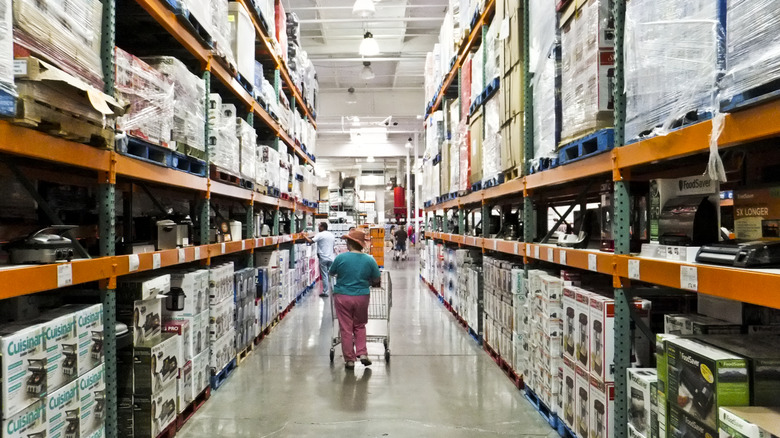Woman walking down Costco aisle