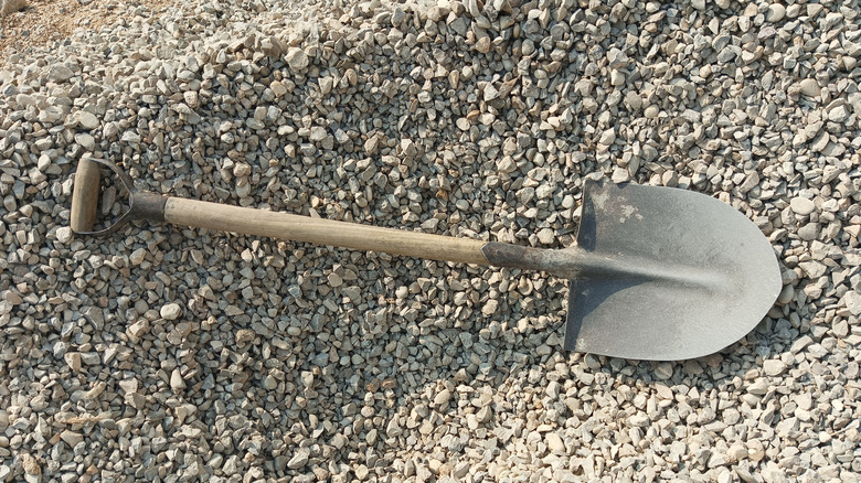A pile of gravel with a shovel on top