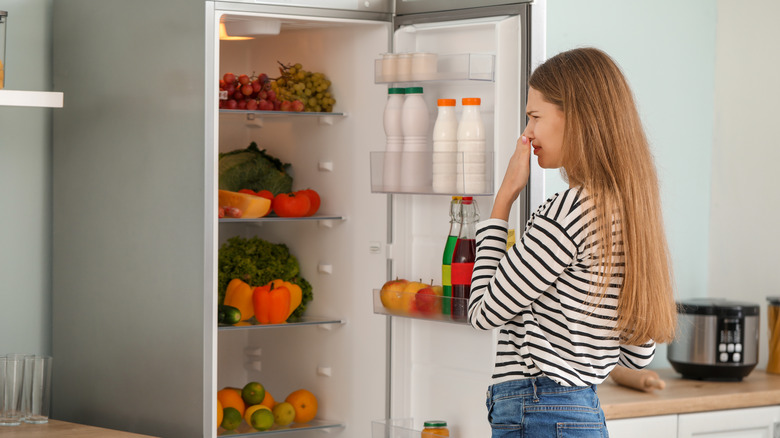 Person in front of smelly fridge