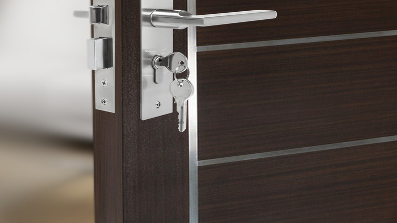 A brushed nickle mortise lockset is installed on a modern door