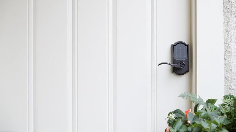 A Schlage Smart Keyless Entry Touchscreen Door Lock is installed on a white exterior door