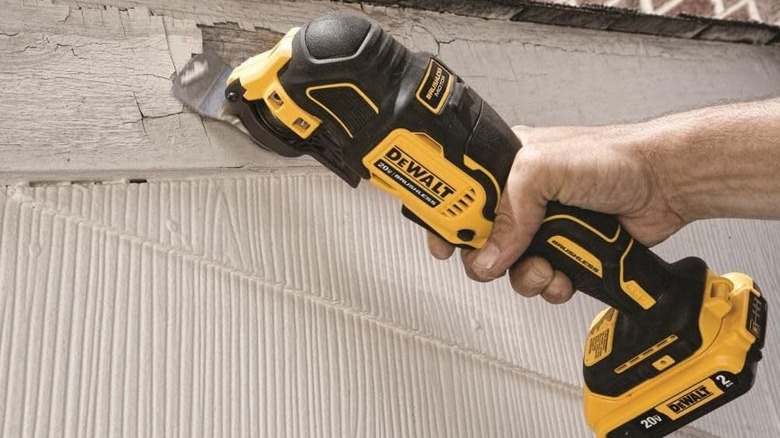 Person using DeWalt oscillating tool