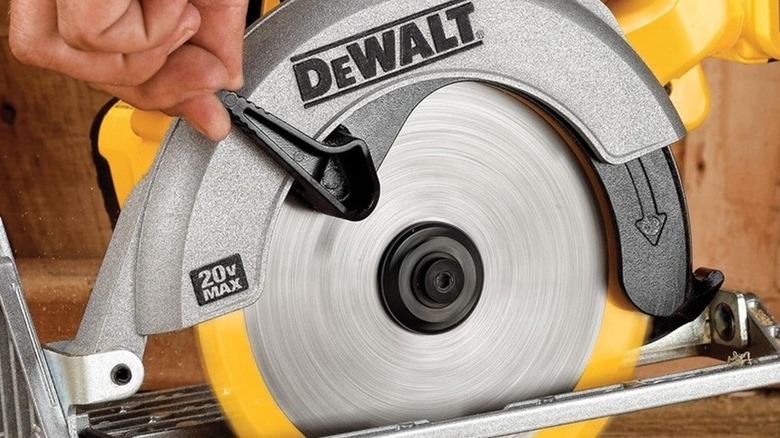 Person adjusting a DeWalt circular saw