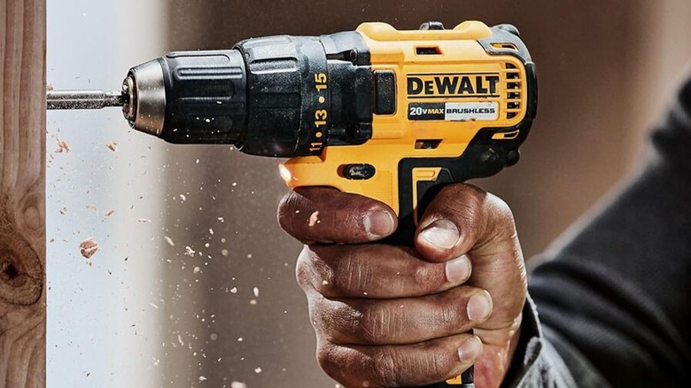 Person using a DeWalt power drill