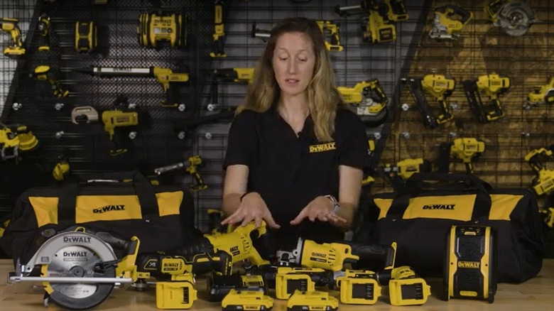 Woman showing off the tools in the DeWalt combo kit