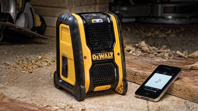 DeWalt Bluetooth speaker playing music on a workbench