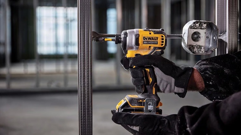 Person using a DeWalt impact driver