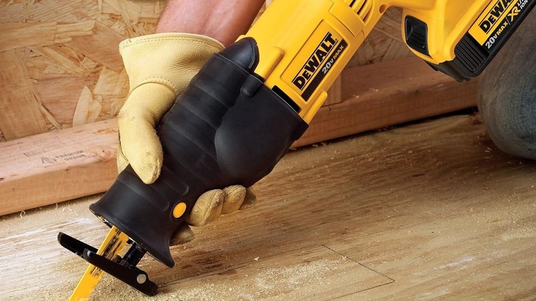 Person using a DeWalt reciprocating saw