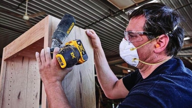 Man using a DeWalt orbital sander