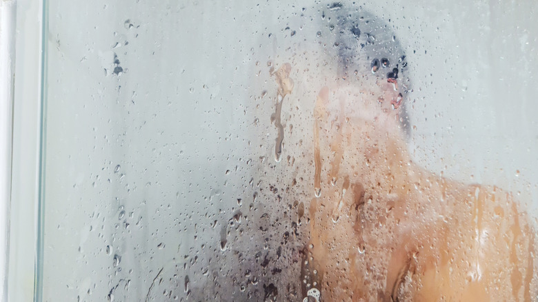 Man in a fogged up shower stall
