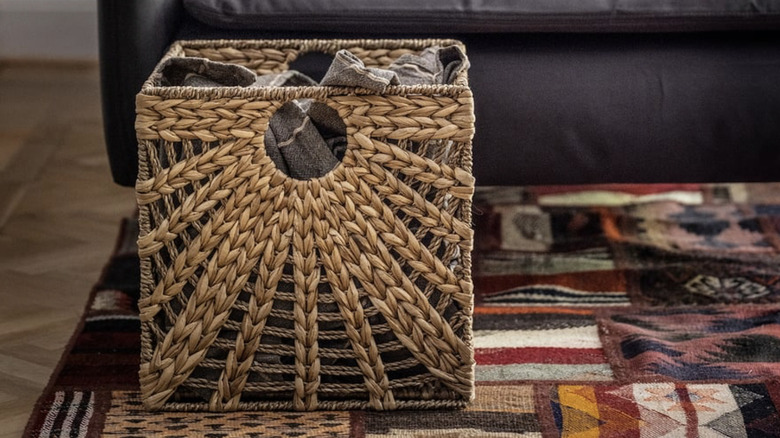 LUSTIGKURRE Basket on a living room floor with a blanket inside