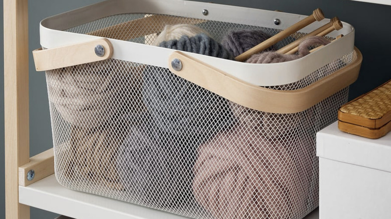 RISATORP Wire basket holding balls of yarn on a shelf