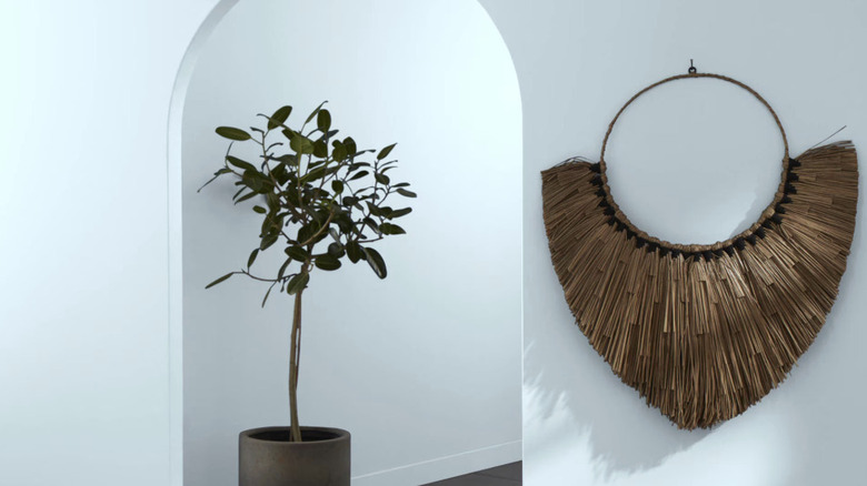 A light blue paint shade in a hallway with a tree and hanging decoration