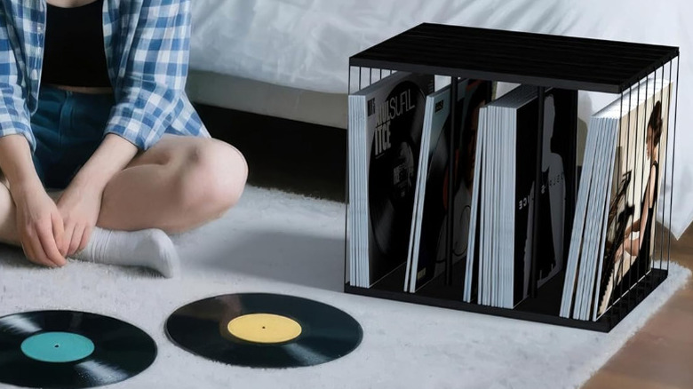 The small Emfongto vinyl record storage cube next to a bed.