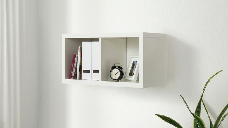 The IKEA KALLAX shelf mounted to a white wall.