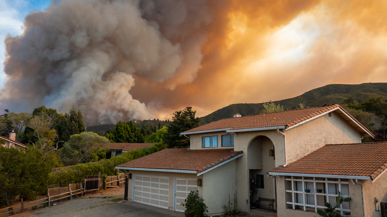 a wildfire behind a house